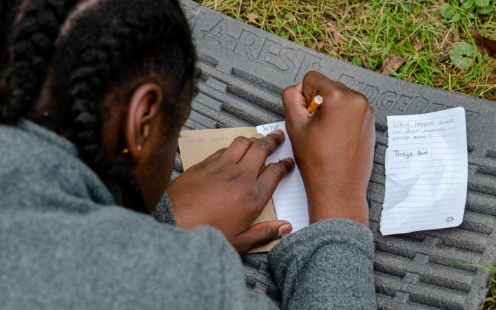 a teen participates in a reflection exercise on an outward bound trip 